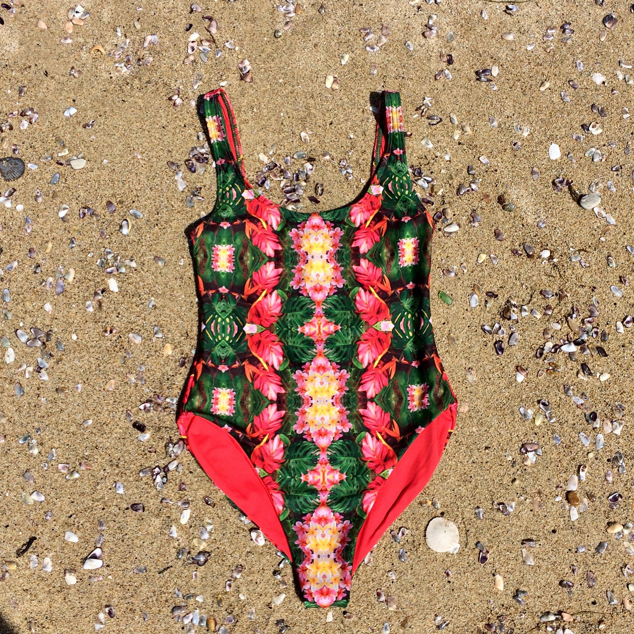 Tropical flowers and plants collaged into this gorgeous unique print. One piece swimsuit made from recycled fabric.