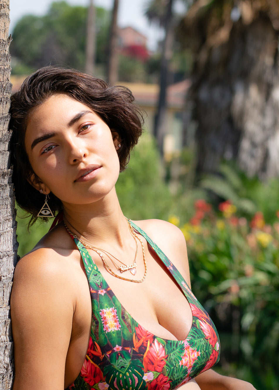 Tropical flowers and plants collaged into this gorgeous unique print. UPF 50 sun protecting fabric. Sustainably made from recycled fabric. Supportive on large busts.